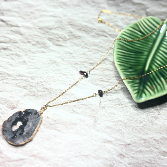 Raw Black Geode Pendant with Garnet Gemstones